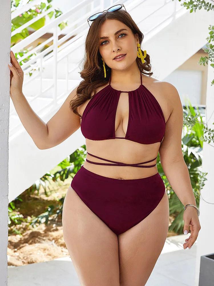 Plus - sized model wearing burgundy two- piece swimsuit