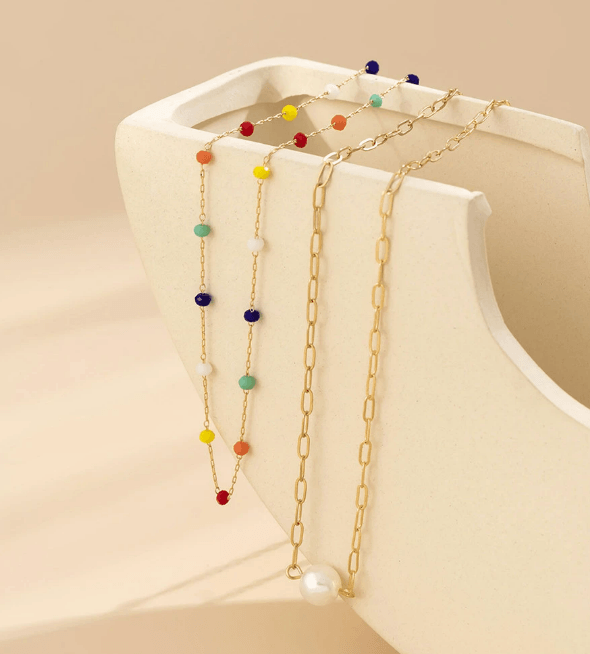 Posed photo of beaded and gold jewellery