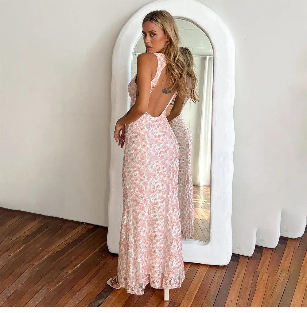 Model showing the back of a pink maxi dress